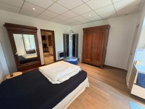 a bedroom with a bed and a dresser in it at Le Clair Briare T2 charmant in Briare