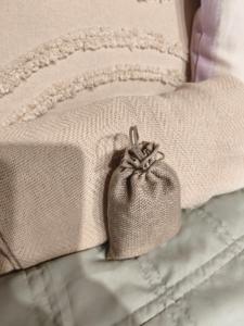 a purse is sitting on top of a bed at Studio Lawendowe Ranczo in Zawichost