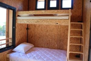 a bedroom with two bunk beds in a room at Eco-Bivouac in La Tagnière