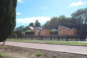 a row of wooden houses on the side of a road at Eco-Bivouac in La Tagnière