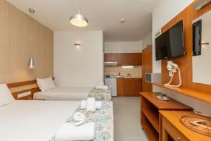 a hotel room with a bed and a sink at Porto Marina in Chrysi Ammoudia