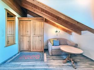 a living room with a couch and a table at Sonnenhof Seeg 15 in Seeg