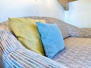 two pillows sitting on a couch in a room at Sonnenhof Seeg 15 in Seeg