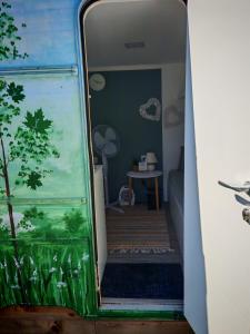 a view of a room with a fish tank on the stairs at Glamping Langus in Topolšica