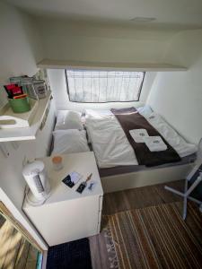 a small room with a bed and a table at Glamping Langus in Topolšica