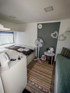 a small room with a bed and a table at Glamping Langus in Topolšica