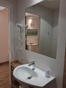 a bathroom with a sink and a large mirror at Hotel Flora in Alba Adriatica +51 photos