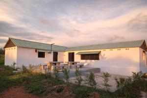 a white house with a green roof at Casa Lantana in Antsiranana +19 photos
