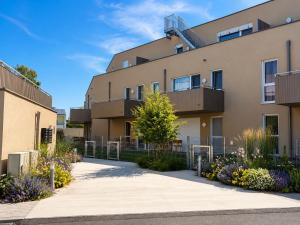 an apartment building with balconies and plants at Am See 18 in Podersdorf am See