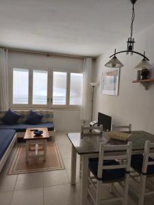 a living room with a table and a couch at Apartamento Blanes Vela Port in Blanes