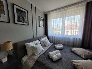 a bedroom with a bed with two towels on it at Apartament Skansen - Sanok in Sanok