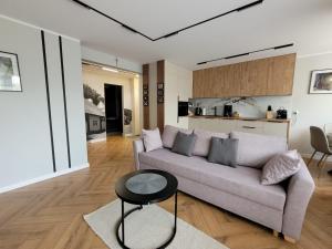 a living room with a couch and a table at Apartament Skansen - Sanok in Sanok