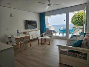 a living room with a view of the ocean at Acapulco Ocean View in San Agustin