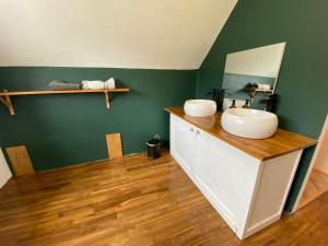 a bathroom with a sink and a mirror at Maison avec sauna en Presqu'île de Crozon pour 6 personnes in Crozon