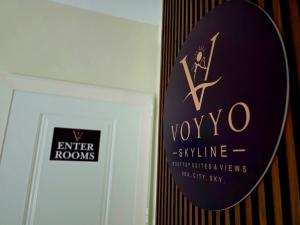a sign on a wall next to a door at Voyyo Skyline in Durrës