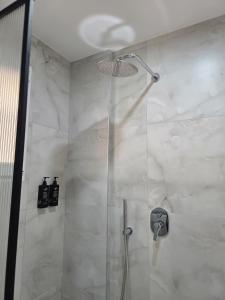 a shower with a glass door in a bathroom at Voyyo Skyline in Durrës +44 photos