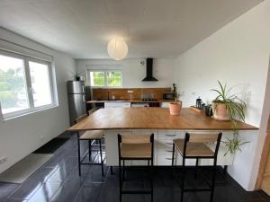 a kitchen with a large wooden table and chairs at Maison avec sauna en Presqu'île de Crozon pour 6 personnes in Crozon