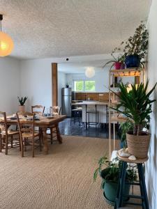 a living room with a table and a dining room at Maison avec sauna en Presqu'île de Crozon pour 6 personnes in Crozon +4 photos