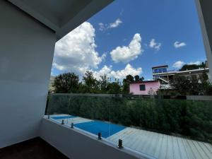 a view from the balcony of a house with a swimming pool at Nagarkoti Residency Inn in Pithorāgarh