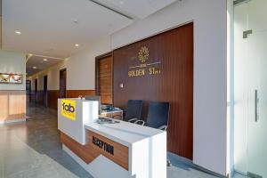 an office with a cubicle with a sign on a wall at FabHotel Golden Stay I in Bangalore