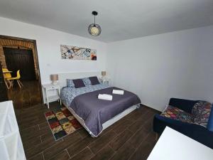 a bedroom with a bed and a couch at Marina Cottage in Enying