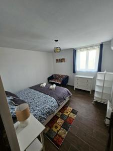 a bedroom with a bed and a table and a window at Marina Cottage in Enying