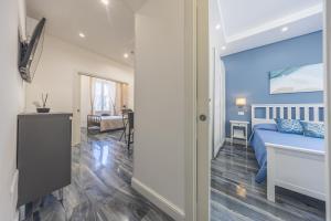 a bedroom with a blue bed in a room at Anzio Central Apartments in Anzio +29 photos