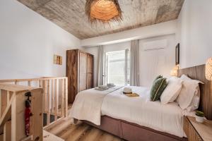 a bedroom with a large bed with a wooden ceiling at Casas dos Machados in Tavira