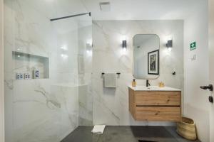 a bathroom with a sink and a mirror at Casas dos Machados in Tavira +85 photos