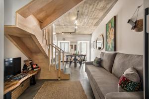 a living room with a couch and a table at Casas dos Machados in Tavira