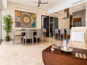 a dining room and living room with a table and chairs at Bucerias, Beachfront Penthouse in Bucerías