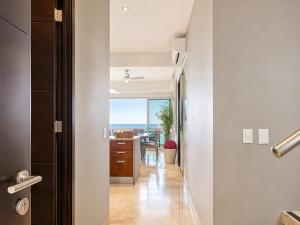 a hallway with a view of the ocean from a house at Bucerias, Beachfront Penthouse in Bucerías
