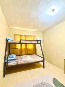 a room with two bunk beds in it at Maru Vibe Guesthouse V2 in San Juan +1 photo