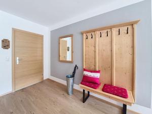 a room with a bench with red pillows on it at Apartment Halbeis by Interhome in Matrei am Brenner +27 photos