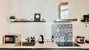 a kitchen with a sink and a counter top at Zen Suite - 50m from Metro M1 - Direct to F1 Monza, Fashion Week, Duomo in Milan