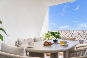 a white table with a plate of food on a balcony at Luxury Residence Mauro in Makarska