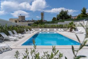 a pool with chaise lounge chairs and a resort at Luxury Residence Mauro in Makarska