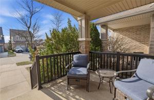 a porch with a chair and a table at Cozy Kitchener-Waterloo Home in Kitchener