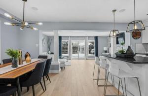 a kitchen and living room with a table and chairs at Cozy Kitchener-Waterloo Home in Kitchener