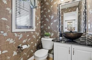 a bathroom with a toilet and a sink at Cozy Kitchener-Waterloo Home in Kitchener +36 photos