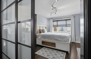 a bedroom with a bed and a window at Cozy Kitchener-Waterloo Home in Kitchener