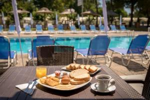 a table with a plate of food next to a pool at Apollo Hotel in Laganas +21 photos