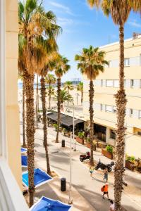 a view from the balcony of a hotel with palm trees at Malvarrosa Beach Rooms in Valencia