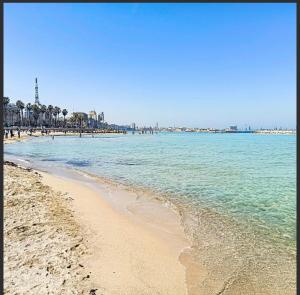 a beach with the ocean and people on it at Eleven Home in Bari