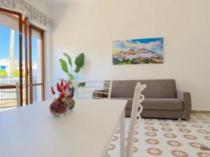 a living room with a white table and a couch at Baia Verde - Dimitri House in Baia Verde