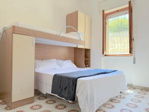 a bedroom with a bed with a bunk bed at Baia Verde - Dimitri House in Baia Verde
