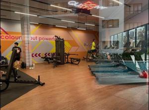 a gym with treadmills and a swimming pool at The Amour Suite in Teluk Panglima Garang
