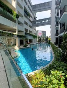 a swimming pool in the middle of a building at The Amour Suite in Teluk Panglima Garang