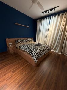 a bedroom with a bed in a room with blue walls at The Amour Suite in Teluk Panglima Garang +3 photos