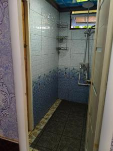 a bathroom with a shower with blue tiles at Geust house Paradise in Arslanbob +22 photos